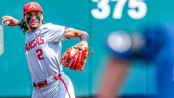 Razorbacks' shortstop Jalen Battles (2) throws to first base against the Ole Miss Rebels during the first inning of the College World Series at Charles Schwab Field.